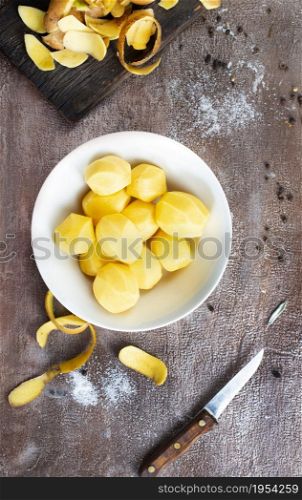 Peeled potatoes for cooking, raw potato on a table