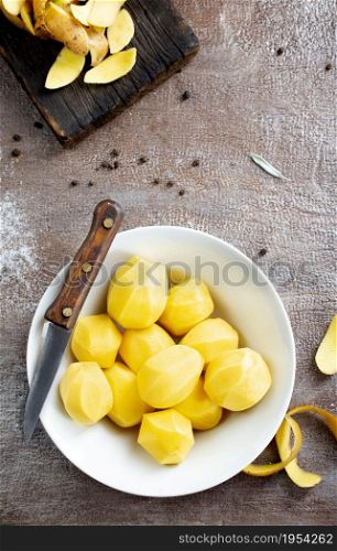 Peeled potatoes for cooking, raw potato on a table