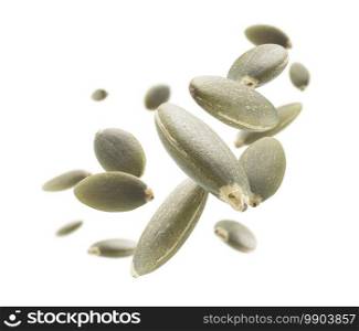 Peeled pumpkin seeds levitate on a white background.. Peeled pumpkin seeds levitate on a white background