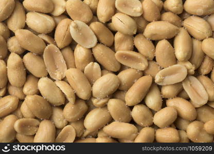 Peeled salted peanuts close up full frame