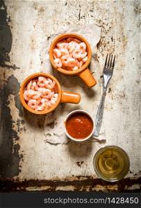 Peeled shrimp with tomato sauce. On rustic background .. Peeled shrimp with tomato sauce.