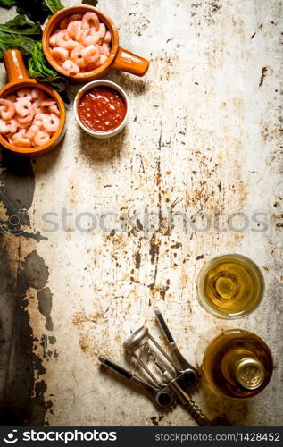 Peeled shrimp with white wine. On rustic background .. Peeled shrimp with white wine.