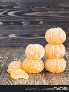 peeled sweet and juicy tangerine in the fruit ripening season, small tangerine in the group. peeled sweet and juicy tangerine