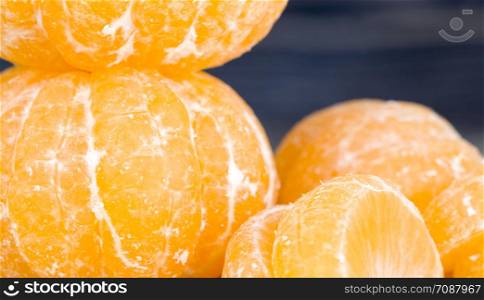 peeled sweet and juicy tangerine in the fruit ripening season, small tangerine in the group. peeled sweet and juicy tangerine