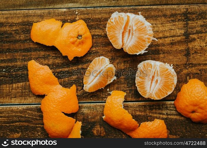 Peeled tangerine on a rustic wooden background