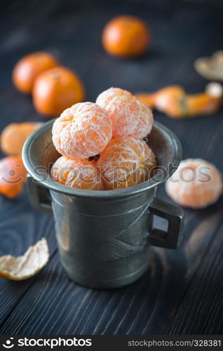 Peeled tangerines in the vintage cup