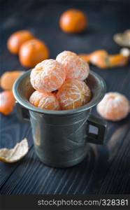 Peeled tangerines in the vintage cup