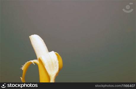 Peeled yellow banana fruit near colorful background space for text, healthy concept colorful. Peeled yellow banana fruit near colorful background space for text, healthy concept