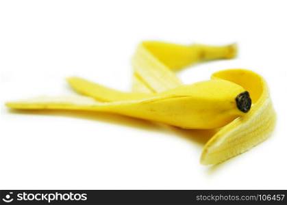 Peeled yellow banana skin on white background, Selective focus