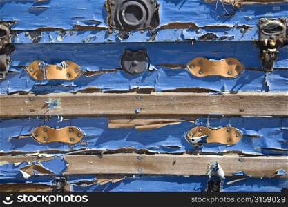 Peeling blue paint on wood