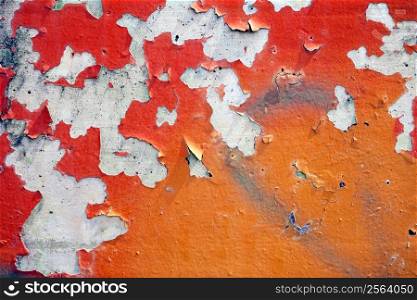 Peeling paint from a concrete wall.