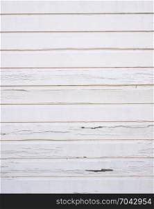 peeling white paint on horizontal wooden planks of shed wall