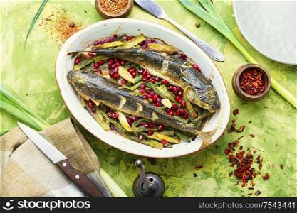 Pelengas baked with vegetables and pomegranate.Tasty baked whole fish. Baked fish with pomegranate