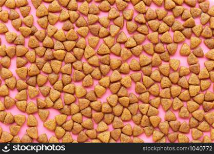 Pellet dog food on the pink background