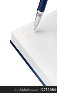 Pen above a notebook. It is isolated on a white background