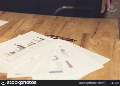 pen and business document on wooden table, selective focus and vintage tone