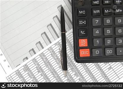 Pen and calculator on paper table with finance diagram