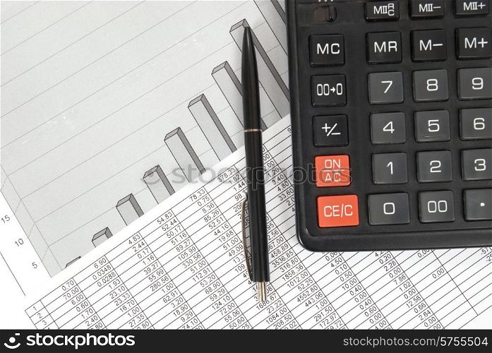 Pen and calculator on paper table with finance diagram