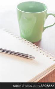 Pen and notebook with green mug, stock photo