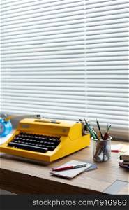 Pen and notepad with vintage typewriter at wood desk table. Writer or study creative concept