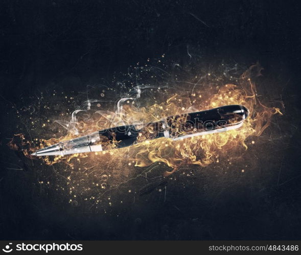 Pen burning in fire. Automatic pen in fire flames on dark background