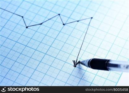 Pen drawing a profit graph. Shallow DOF!