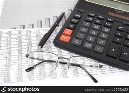 Pen, glasses and calculator on paper table with finance diagram