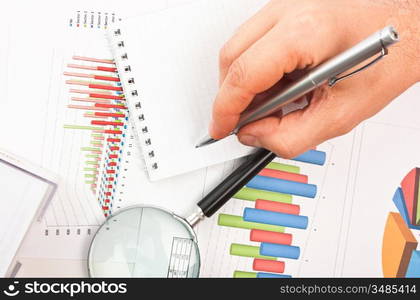 pen in hand and working paper chart