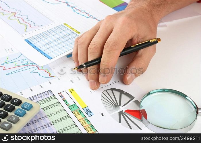 pen in hand and working paper chart