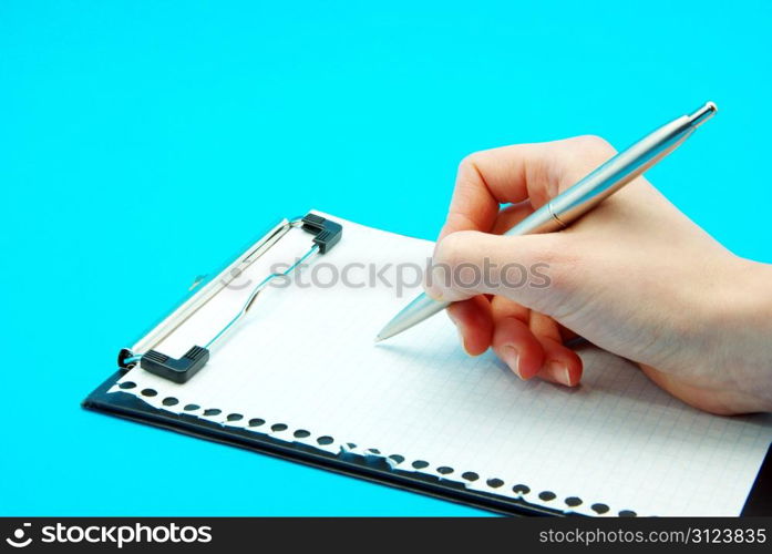 Pen in hand isolated on blue background