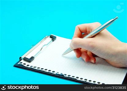 Pen in hand isolated on blue background