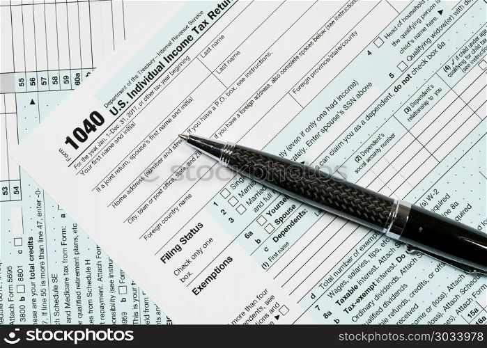 Pen laying on 2017 IRS form 1040. USA IRS tax form 1040 for year 2017 with pen and taken from above. Pen laying on 2017 IRS form 1040