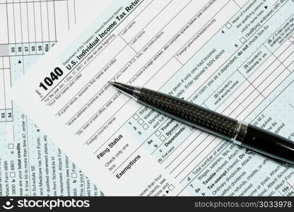 Pen laying on 2017 IRS form 1040. USA IRS tax form 1040 for year 2017 with pen and taken from above. Pen laying on 2017 IRS form 1040