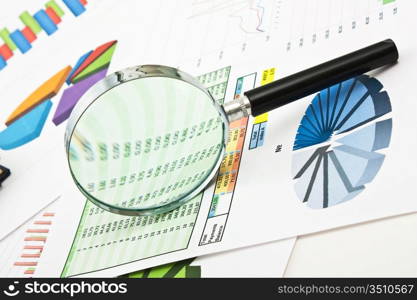 pen, magnifying glass and the working paper with a diagram