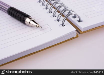 Pen on notebook on a white background