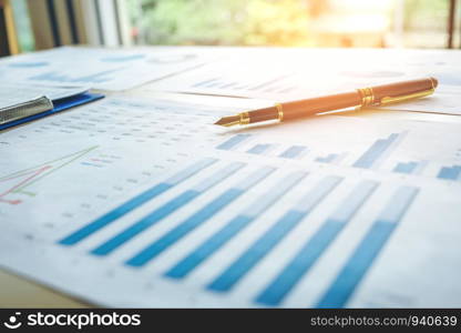 Pen on the business paper. Report chart