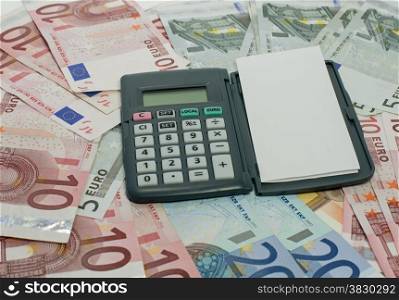 pen with paper and calculator euro money