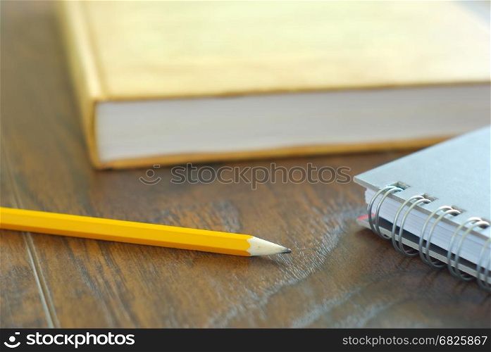 Pencil book notebook student study accesories. Education stationary closeup. Drawing pencil on desk home workplace.