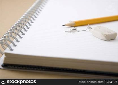 pencil, eraser and eraser leftovers on notebook