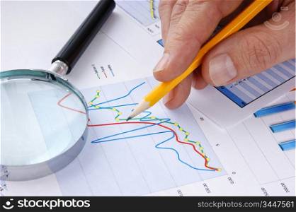 pencil in hand and working paper chart
