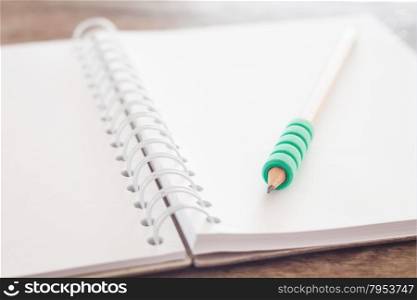 Pencil on open blank notebook, stock photo