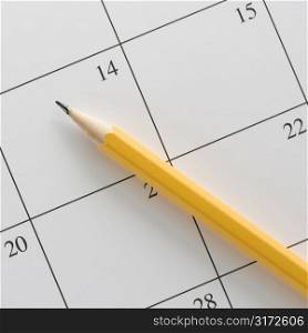 Pencil on top of a blank calendar.
