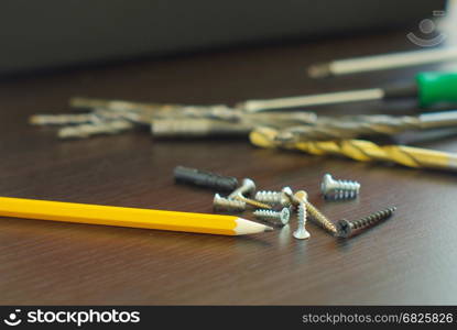 Pencil with metal screws engineering construction idea. Fix tool household. Home repair tools.