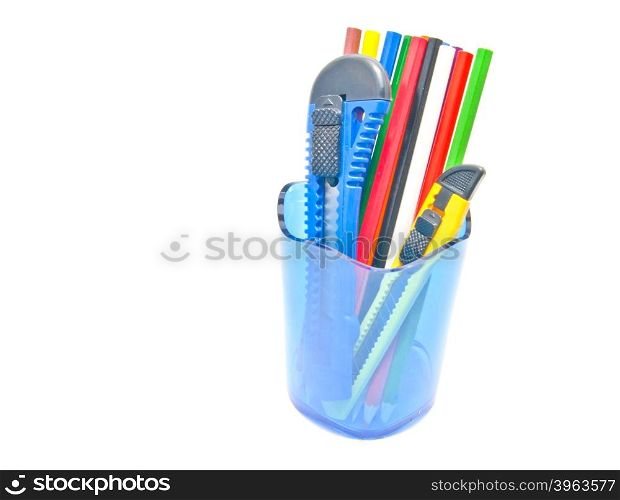 pencils and knifes in container close-up on white background