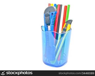 pencils and knifes in container on white