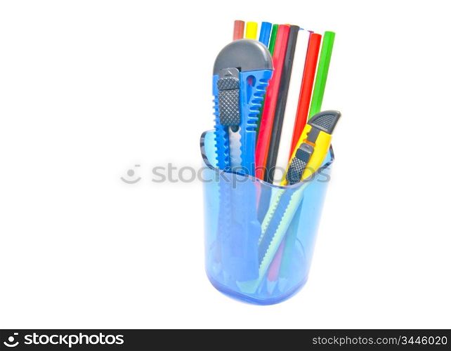 pencils and knifes in container on white background