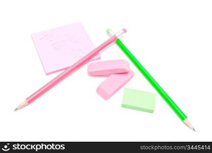 pencils, erasers and sticky note on white background