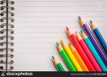 Pencils in various colors on linear paper