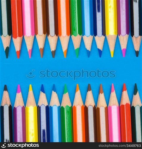 Pencils of many colors a over blue background