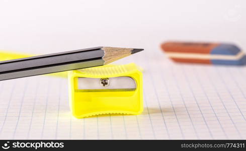 Pencils with pencil sharpener and eraser isolated on white background